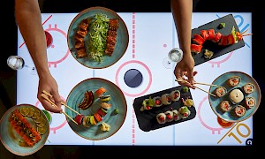 dishes on new interactive tables in Covent Garden with air hockey beneath